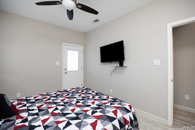 bedroom with light hardwood / wood-style floors and ceiling fan