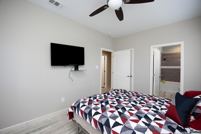 1403 S Young, Rockport, TX 78382 - bedroom with light wood finished floors, a ceiling fan, baseboards, and connected bathroom