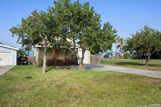 view of front of house with a garage, a front yard, and a porch