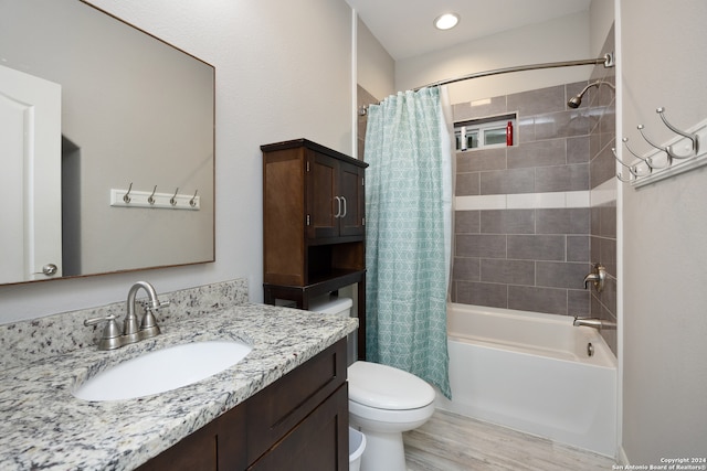 full bathroom with shower / tub combo with curtain, vanity, wood-type flooring, and toilet