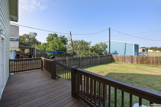 wooden terrace featuring a lawn