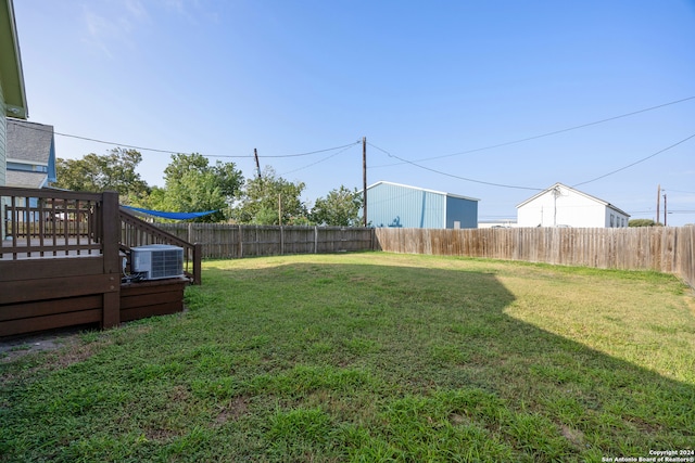 view of yard featuring central air condition unit and a deck