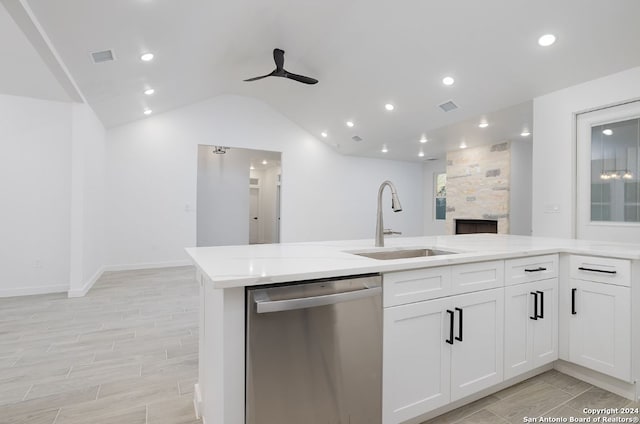 kitchen featuring light wood-type flooring, sink, white cabinets, dishwasher, and lofted ceiling