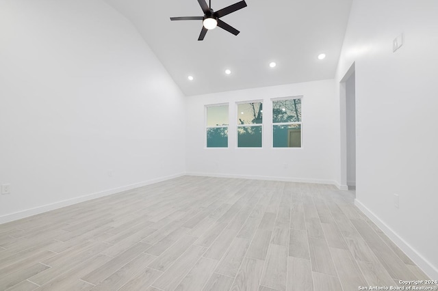 spare room featuring ceiling fan, light wood-type flooring, and high vaulted ceiling