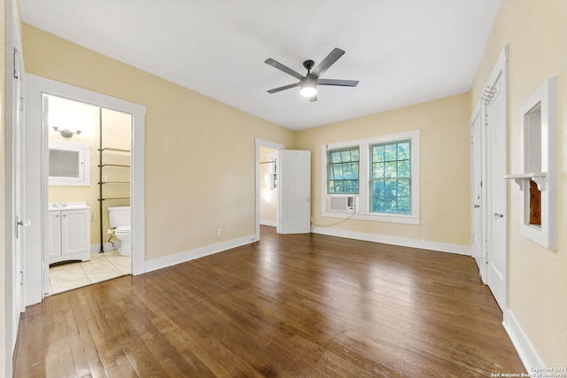 unfurnished bedroom featuring connected bathroom, ceiling fan, and light hardwood / wood-style floors