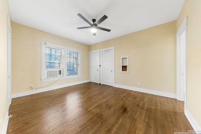 unfurnished bedroom with ceiling fan, cooling unit, and dark hardwood / wood-style flooring