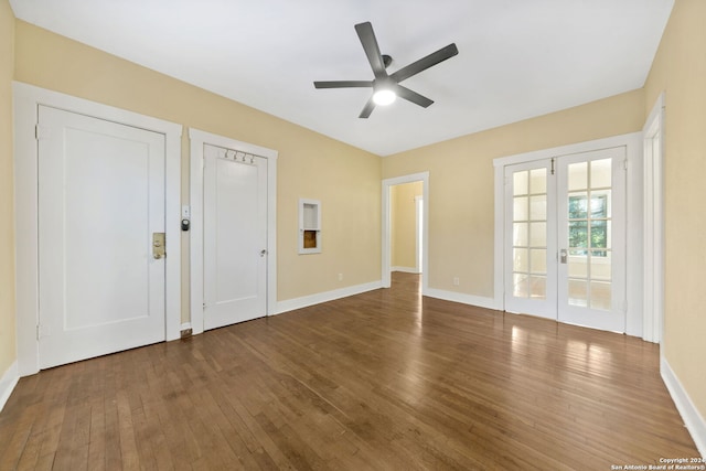 spare room featuring ceiling fan, french doors, and dark hardwood / wood-style floors