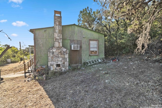 view of side of property featuring a wall mounted air conditioner