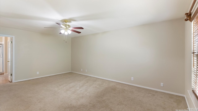 empty room featuring light colored carpet and ceiling fan