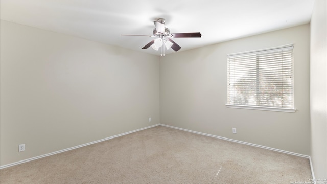 empty room featuring light colored carpet and ceiling fan