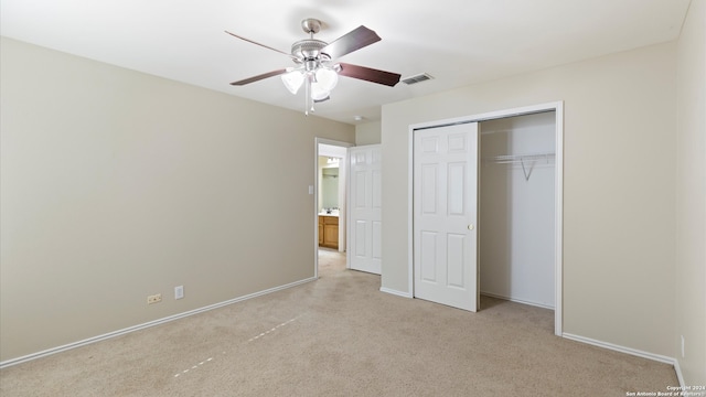 unfurnished bedroom with light colored carpet, ceiling fan, and a closet