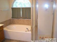 bathroom with independent shower and bath and vanity