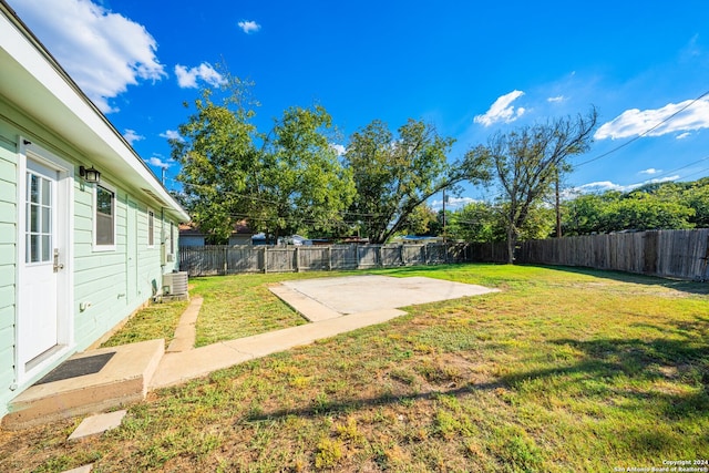 view of yard featuring central air condition unit and a patio