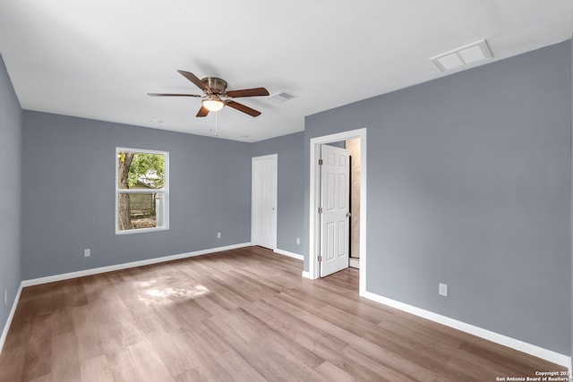 empty room featuring ceiling fan and light hardwood / wood-style flooring