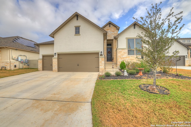 view of front property featuring a front lawn and a garage