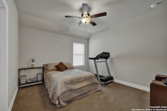 bedroom with lofted ceiling, dark carpet, and ceiling fan