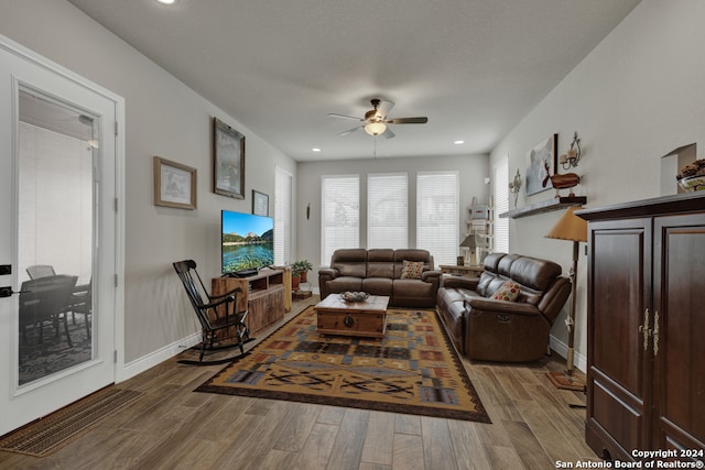 living room with hardwood / wood-style floors and ceiling fan