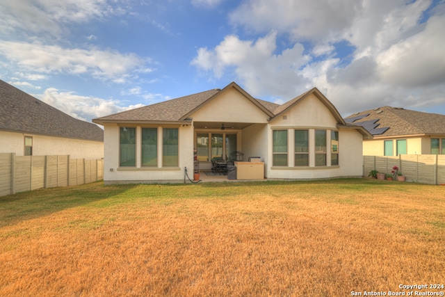 back of house featuring ceiling fan, a yard, and a patio area