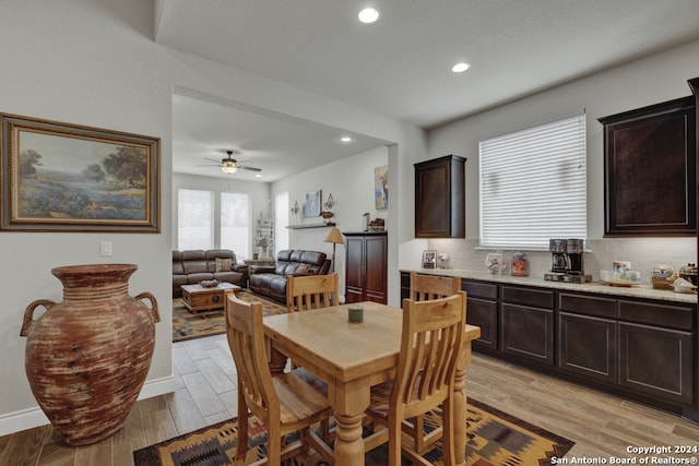 dining room with light wood-type flooring and ceiling fan