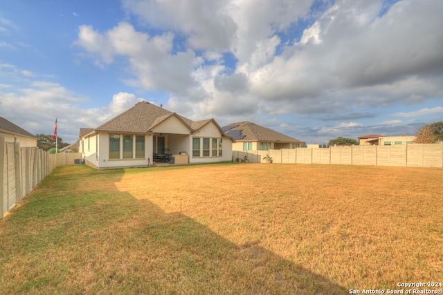 rear view of house with a lawn