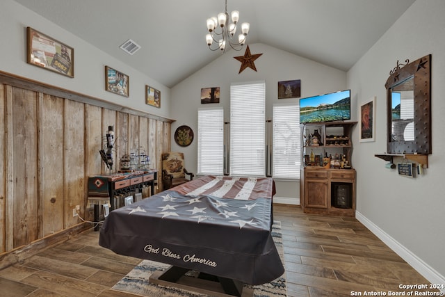 bedroom with dark hardwood / wood-style flooring, a notable chandelier, and vaulted ceiling