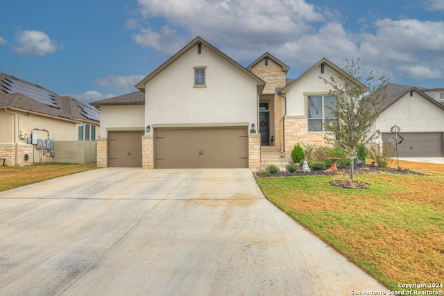 view of front facade featuring a garage and a front yard