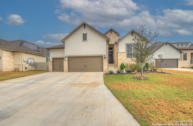 view of front of home with a garage and a front lawn