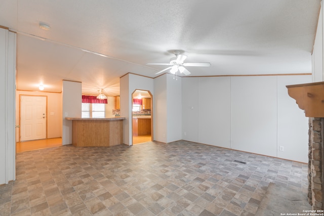 unfurnished living room featuring a textured ceiling and ceiling fan