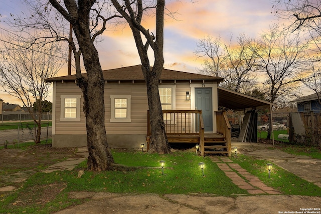 view of back house at dusk