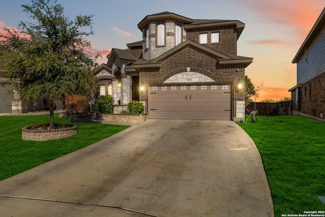 view of front of home featuring a garage and a yard