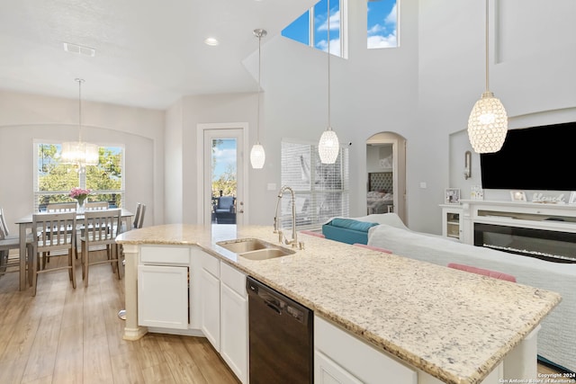 kitchen featuring a center island with sink, white cabinetry, light wood-type flooring, sink, and dishwasher