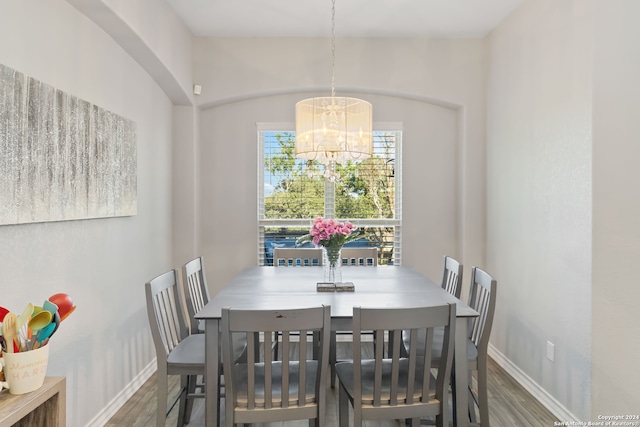 dining space featuring a notable chandelier and hardwood / wood-style flooring