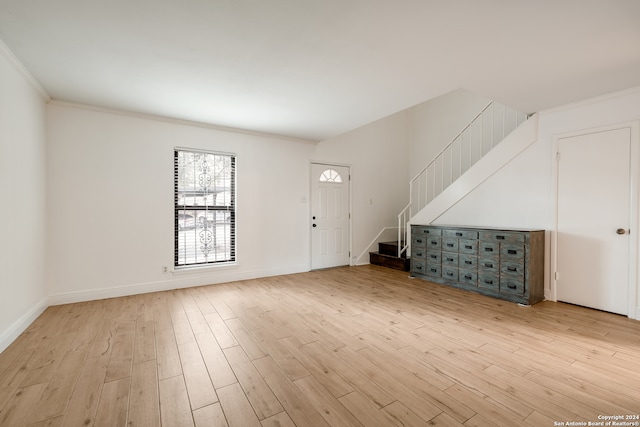 interior space with light wood-type flooring and crown molding