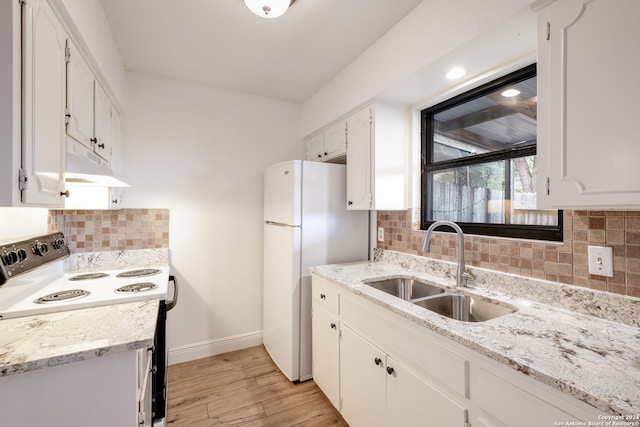 kitchen with light hardwood / wood-style floors, white cabinetry, sink, white appliances, and decorative backsplash