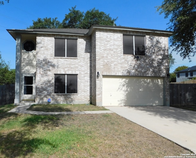 view of front of house featuring a garage and a front yard