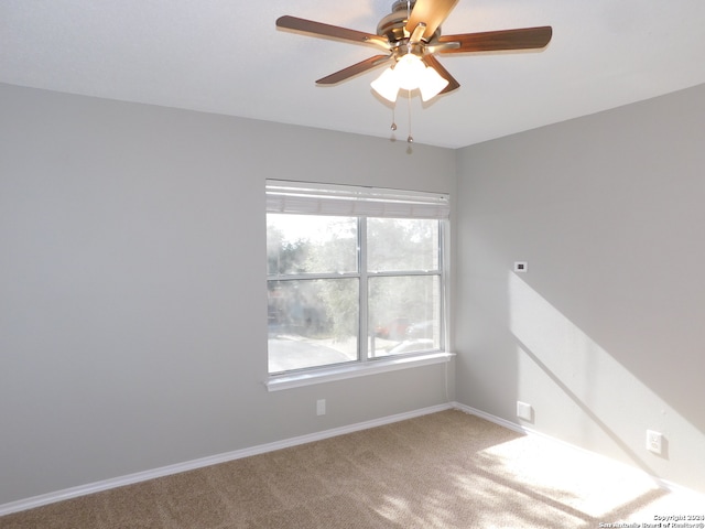 spare room featuring ceiling fan and carpet flooring