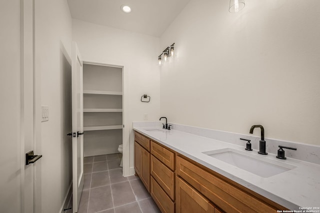 bathroom with tile patterned flooring, vanity, and toilet