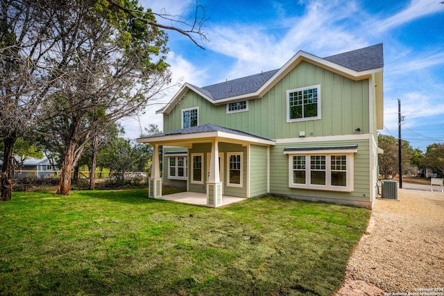 back of house with central air condition unit, a patio, and a yard