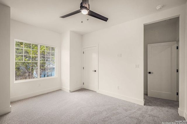 unfurnished bedroom with light carpet and ceiling fan