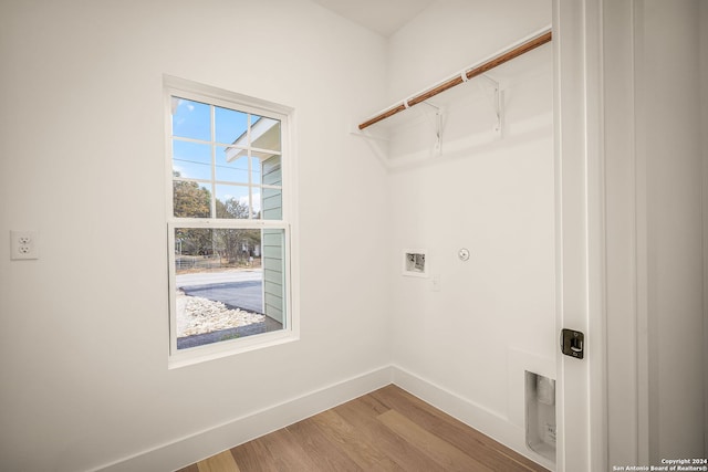 laundry room with wood-type flooring and hookup for a washing machine