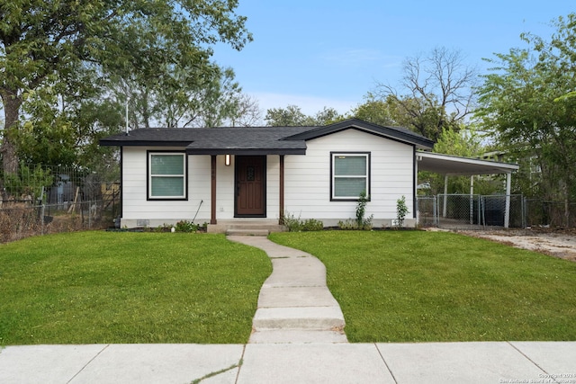 view of front facade featuring a carport and a front lawn