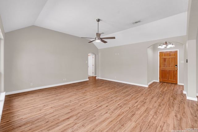 unfurnished living room with light wood-type flooring, vaulted ceiling, and ceiling fan with notable chandelier