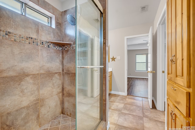 bathroom with vanity, tile patterned flooring, and a shower with door