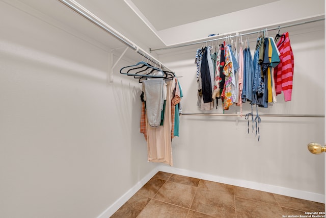 walk in closet with tile patterned floors