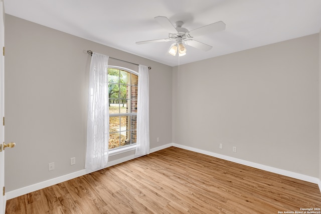 spare room featuring light hardwood / wood-style floors and ceiling fan