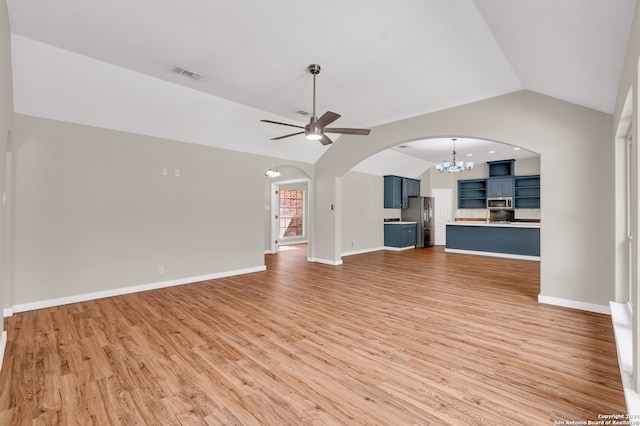 unfurnished living room featuring light wood-type flooring, vaulted ceiling, and ceiling fan with notable chandelier