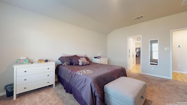 carpeted bedroom featuring lofted ceiling