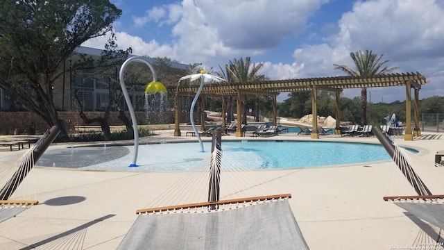 view of swimming pool with a patio, a pergola, and pool water feature