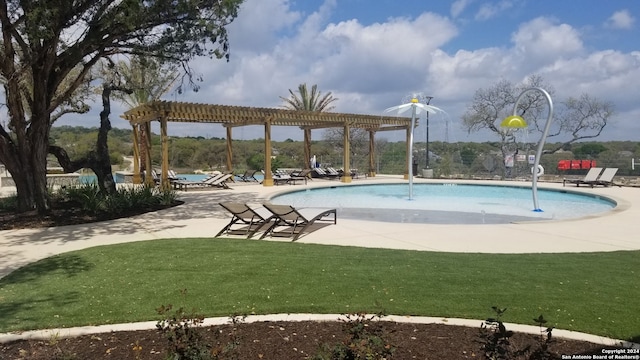 view of swimming pool with a pergola, pool water feature, a yard, and a patio area