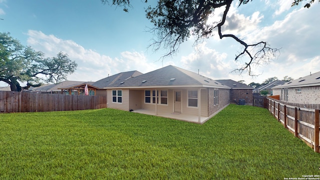 rear view of property featuring central AC unit, a patio, and a lawn